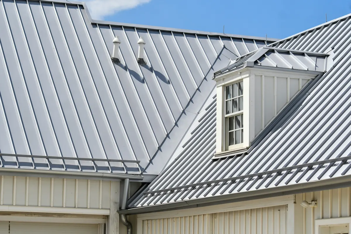 Standing-seam metal roof with a dormer and pipe penetrations