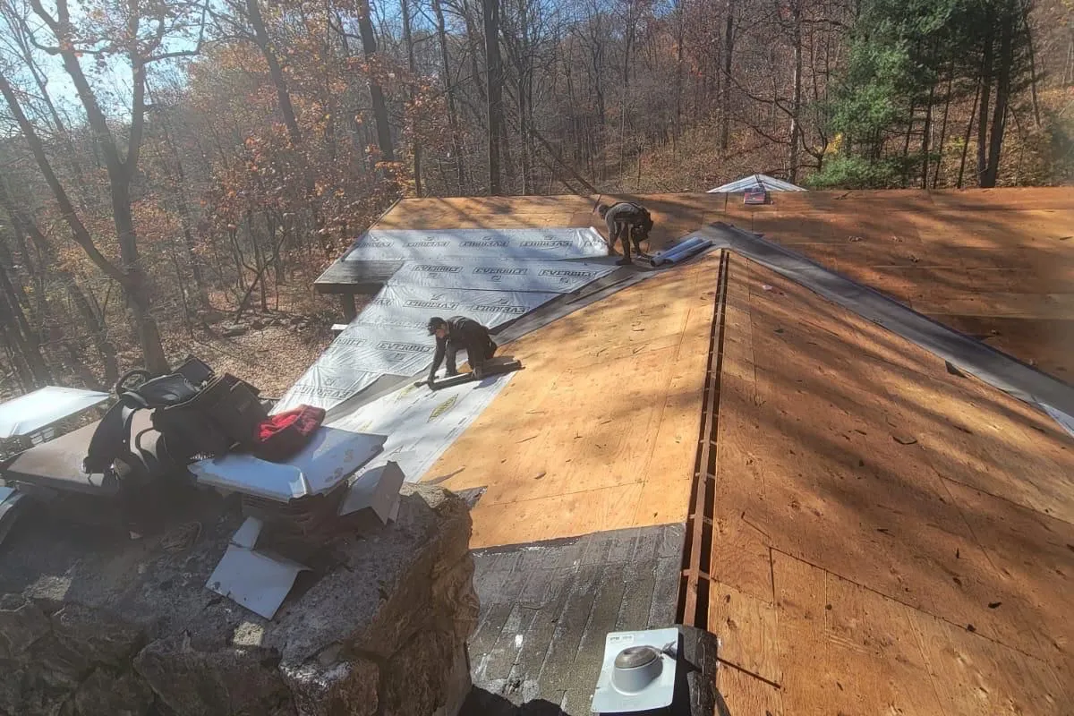 Exposed wood roof deck during roofing work