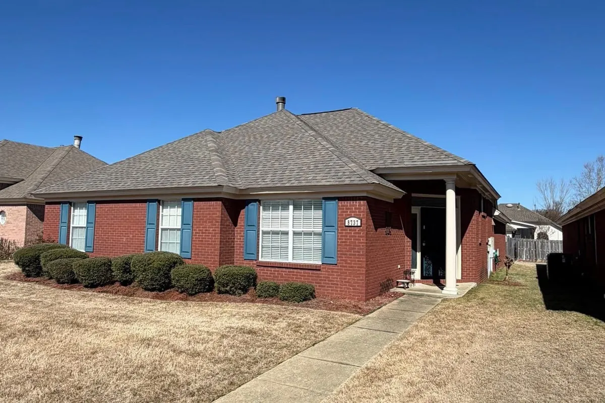 Shingle roof on a brick home photographed for Effective