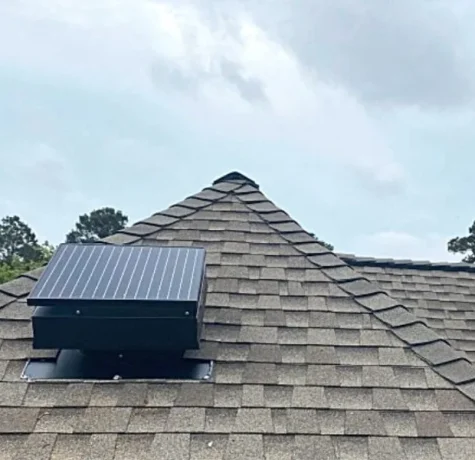 Worker adding insulation in a residential attic.