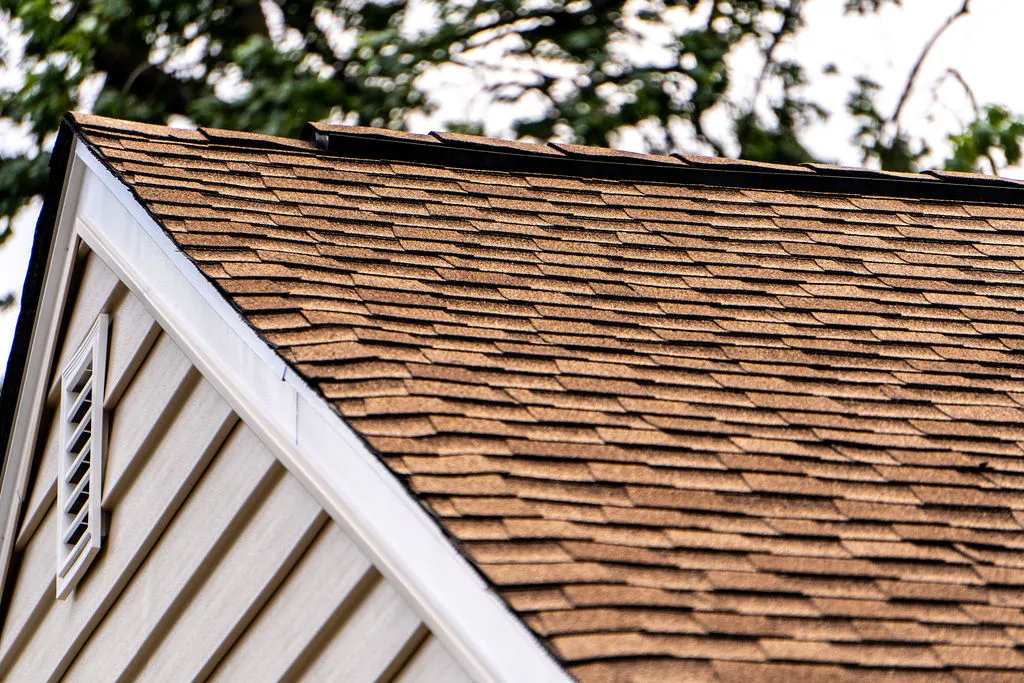 Technician inspecting a commercial flat roof.