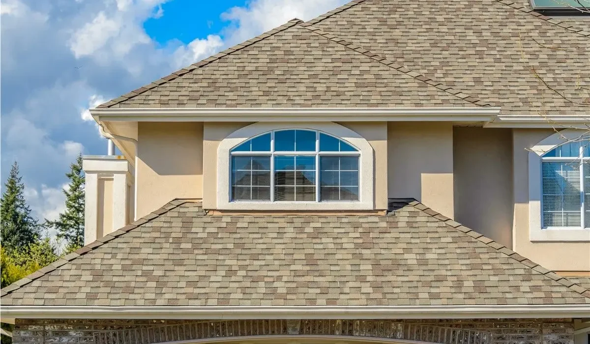Homeowner taking photos of roof damage for an insurance claim.
