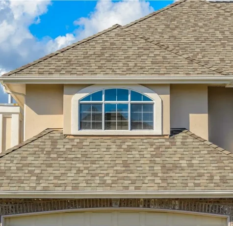 Homeowner taking photos of roof damage for an insurance claim.