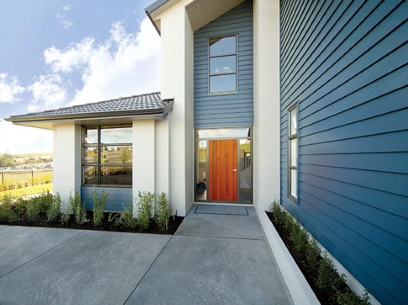 Modern home with blue fiber cement siding installation in New Jersey